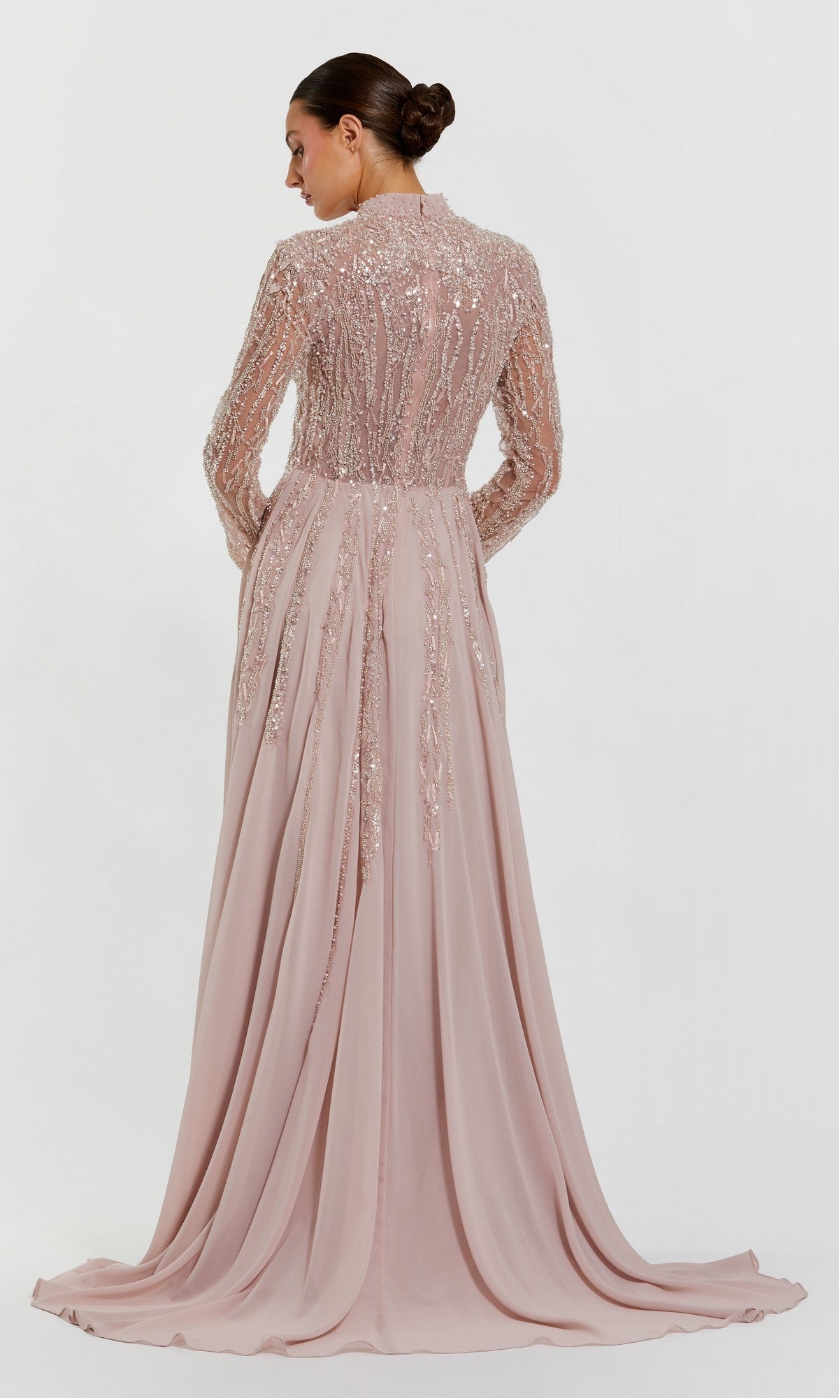 Woman in the Mac Duggal 37037 long formal dress, featuring bead embellishments and long sleeves, stands with her back to the camera against a plain white background.